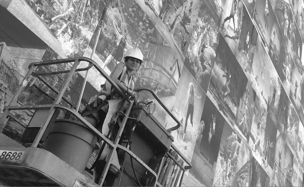 Photo of Eyoalha Baker working on the Wall of Joy Mural by Alexandre Legere